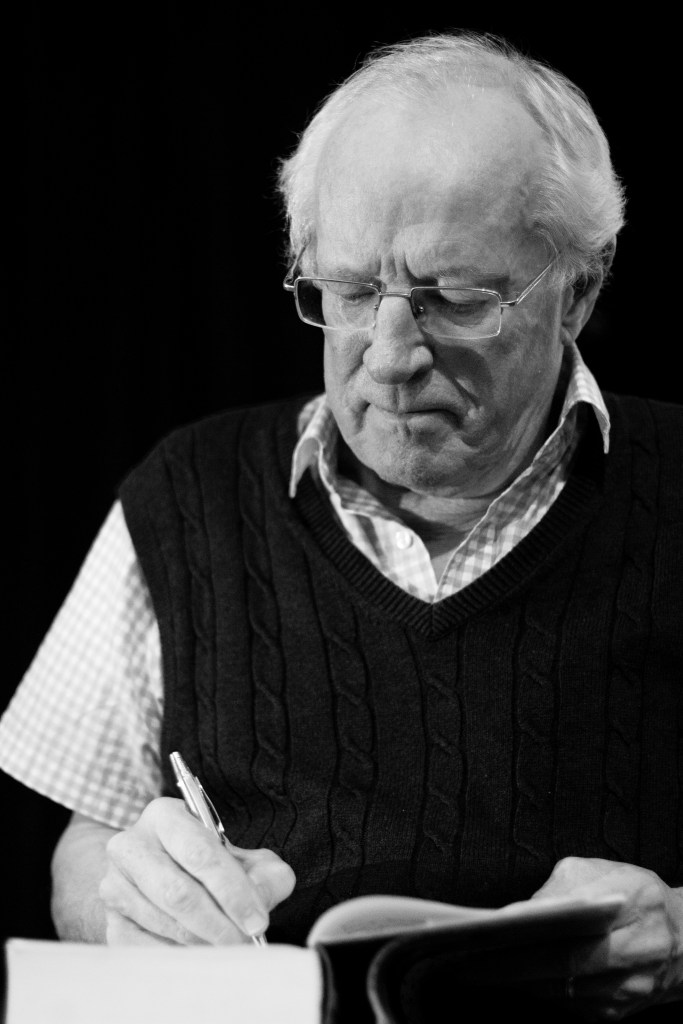 Robert Fisk signing a book