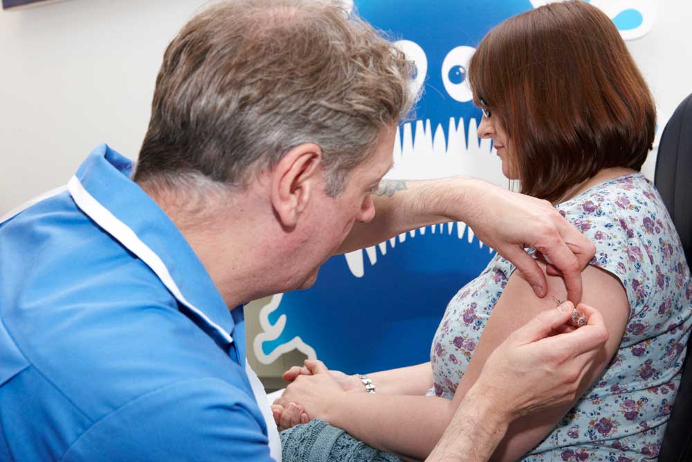 Nurse gives flu jab
