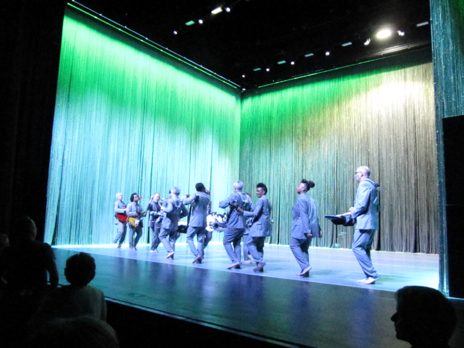 The performers in Utopia dance on the stage and play their instruments