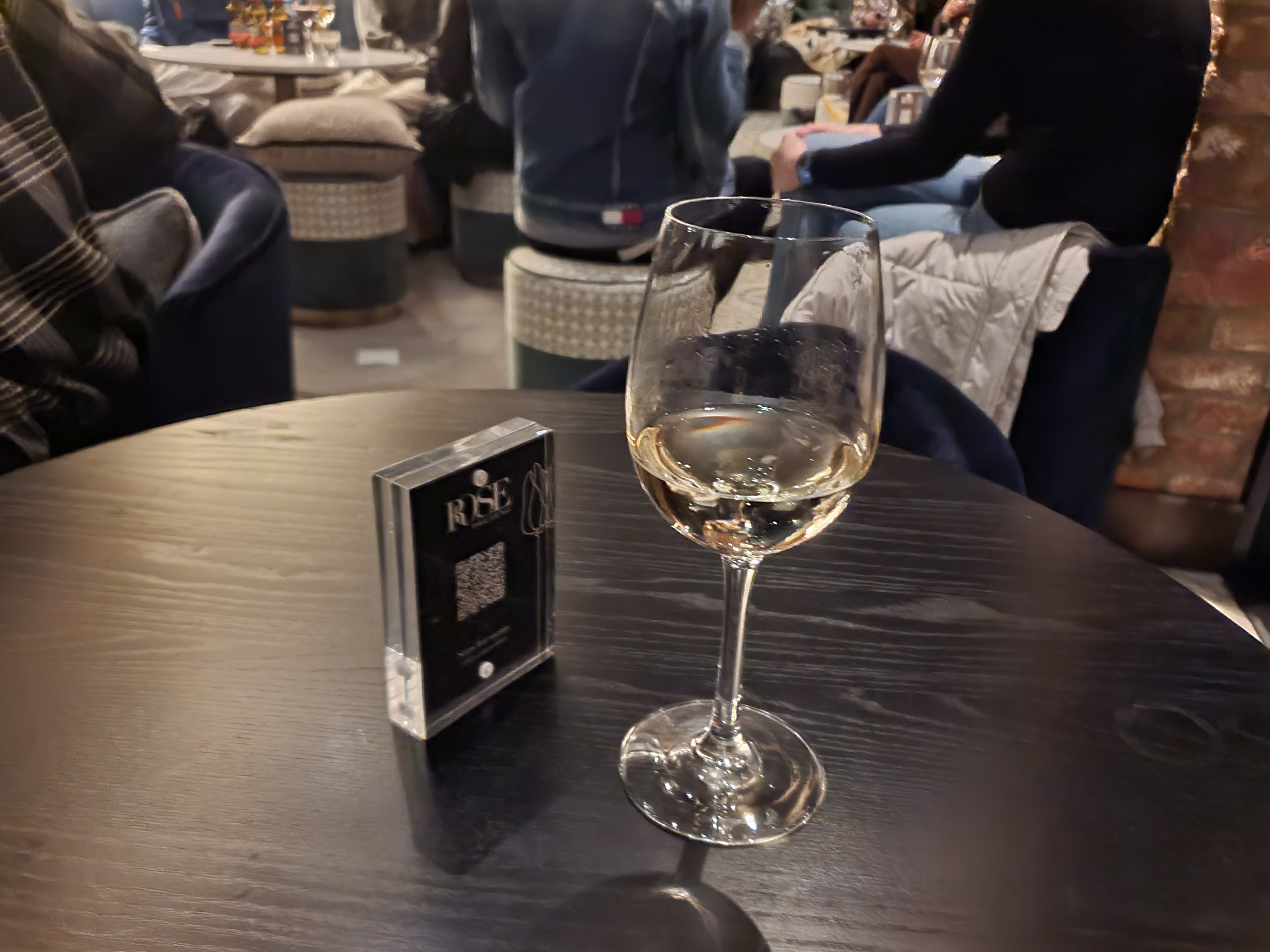 A glass of wine on a black table