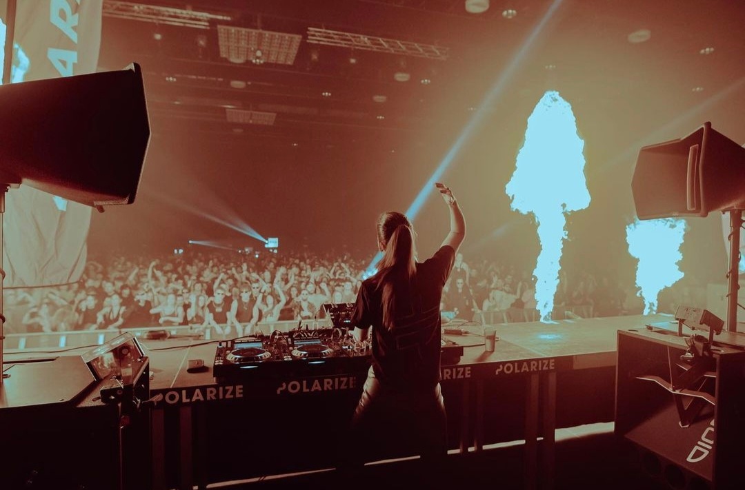 DJ Lilly Palmer plays as the fire makes a mushroom-like shape