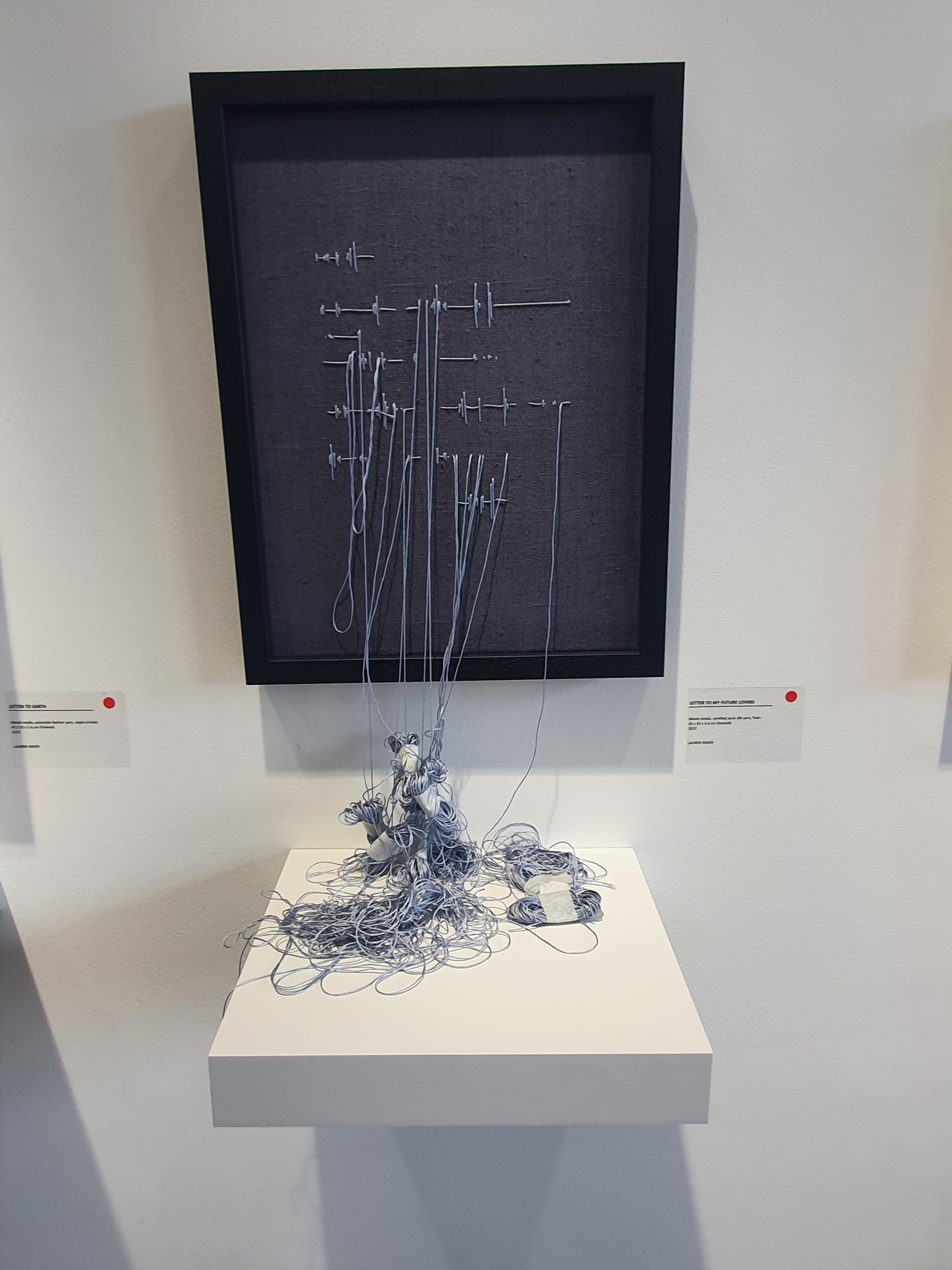 As well as blowing in the summery breeze the cornflower blue thread is tied up and resting on a ledge in the artwork Letter to My Future Lovers