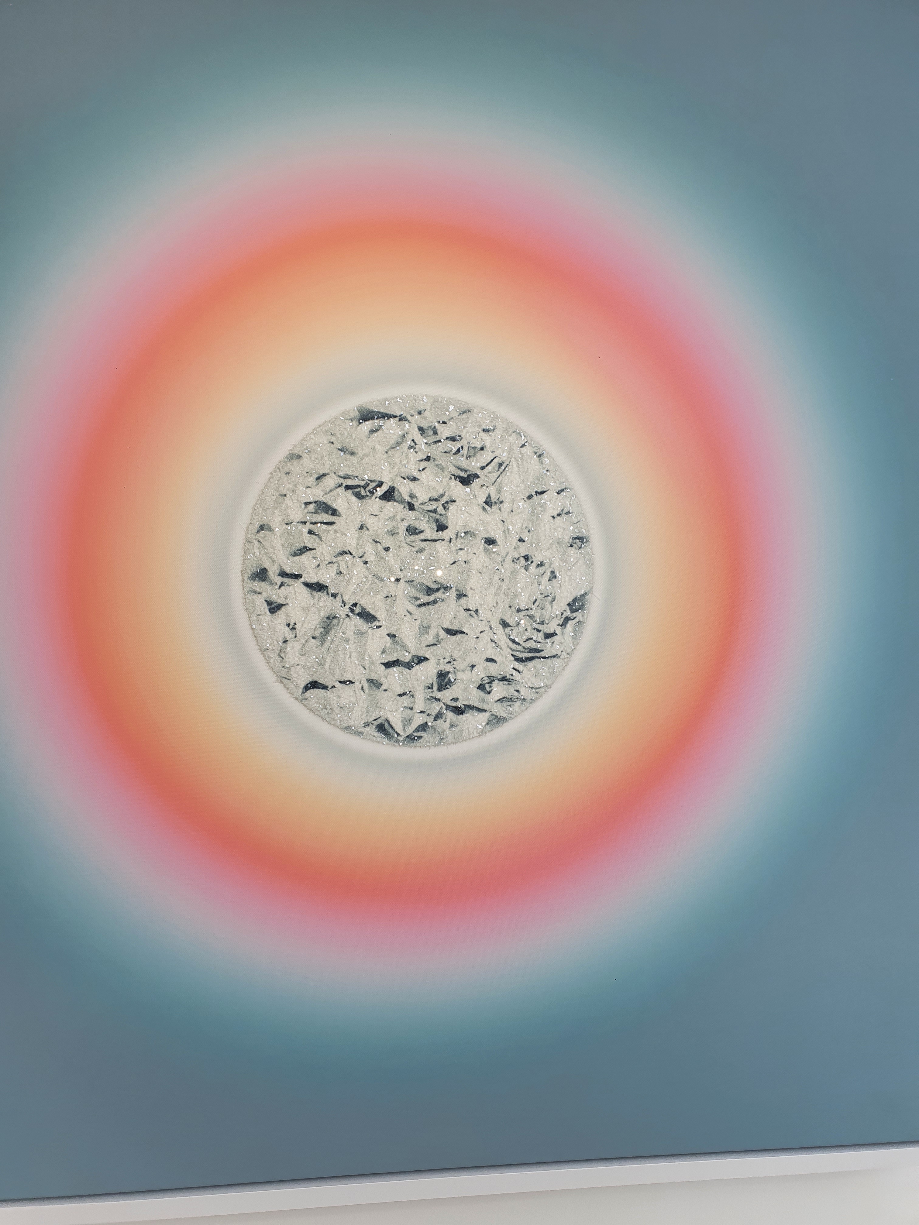 Peachy oranges, pale rose pinks and fiery yellows form a halo around the craggy Moon which sparkles with diamond dust