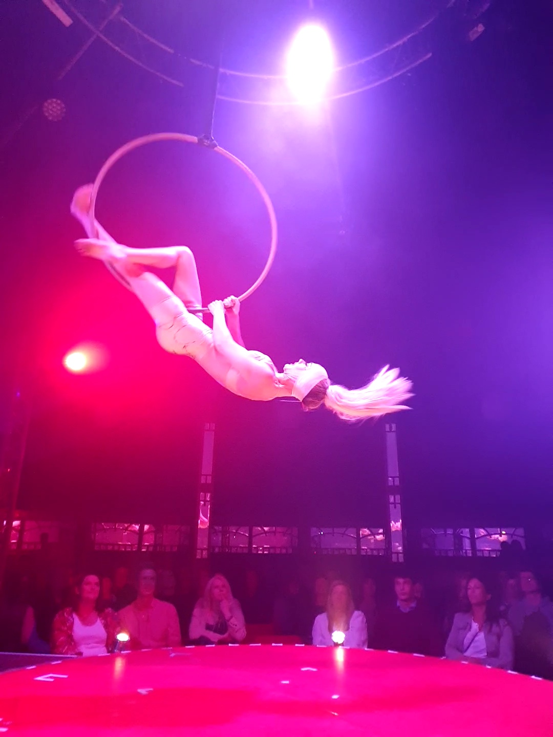 Katharine Arnold is upside down in an aerial hoop